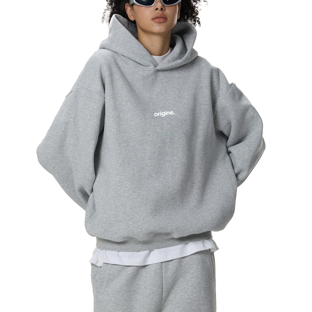 Unisex streetwear hoodie from Origine, minimalist oversized design in soft cotton, perfect for everyday wear. Designed for Dreamers – modern essential with subtle urban aesthetic.