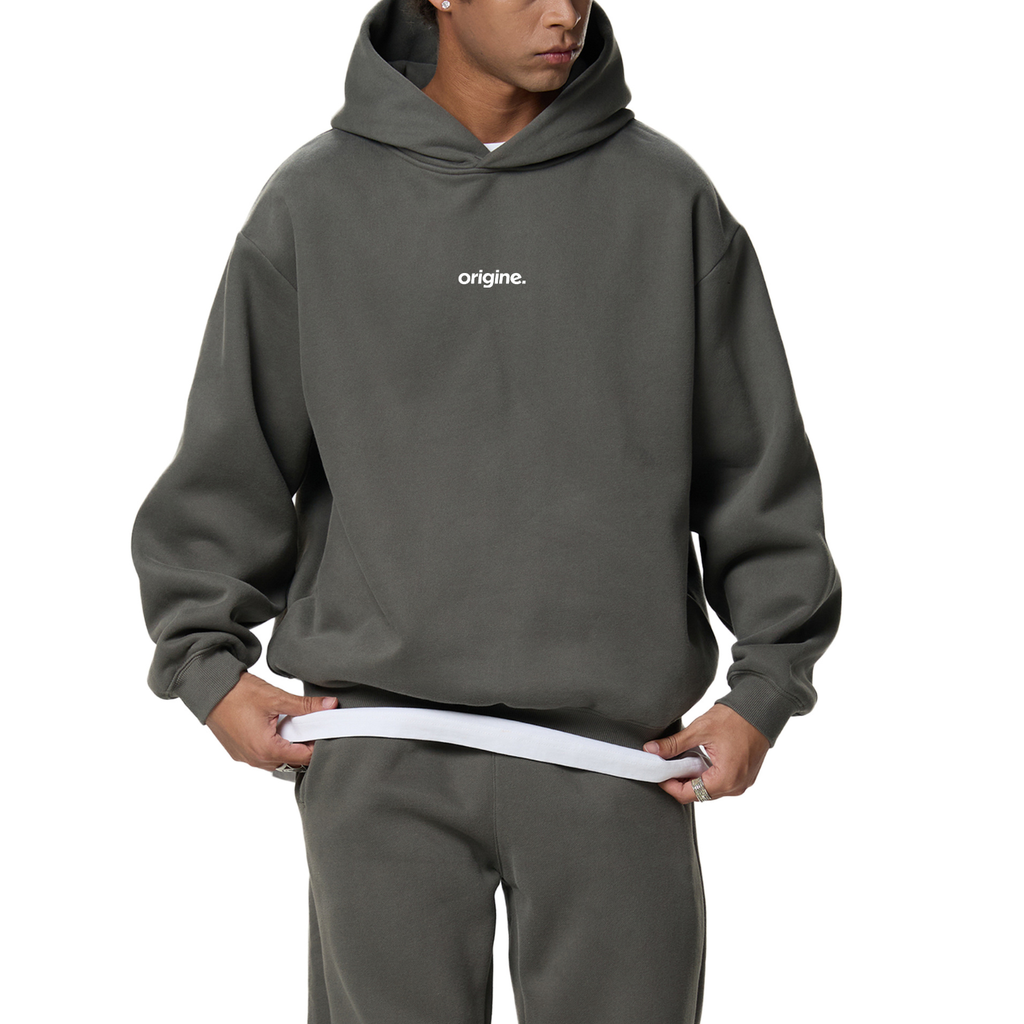 Unisex streetwear hoodie from Origine, minimalist oversized design in soft cotton, perfect for everyday wear. Designed for Dreamers – modern essential with subtle urban aesthetic.